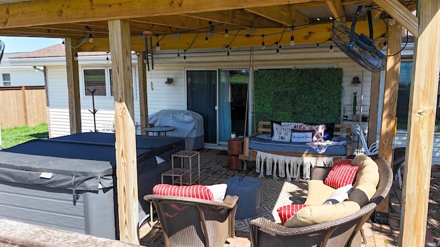 view of patio with area for grilling and fence