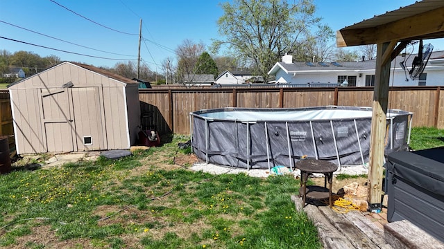 8355 Kifer Dr, Newburgh, IN 47630 - view of yard with a fenced in pool, a fenced backyard, an outbuilding, and a storage unit