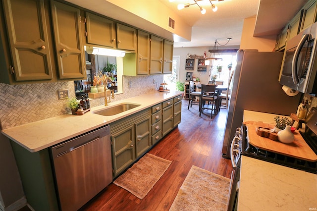 kitchen with dark wood-style flooring, visible vents, green cabinetry, and stainless steel appliances