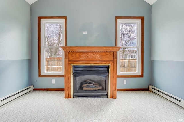 unfurnished living room featuring a wealth of natural light, carpet, and a baseboard heating unit