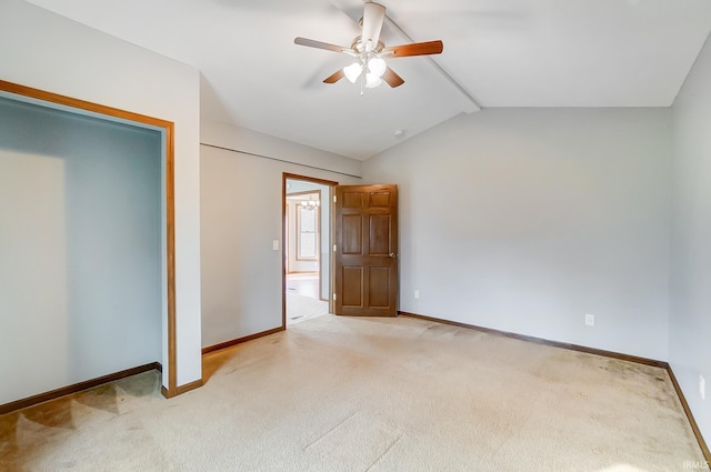 unfurnished bedroom featuring light carpet, ceiling fan, baseboards, and lofted ceiling with beams