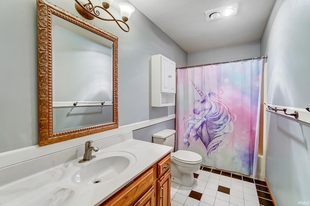 full bath with tile patterned flooring, vanity, a textured ceiling, and toilet