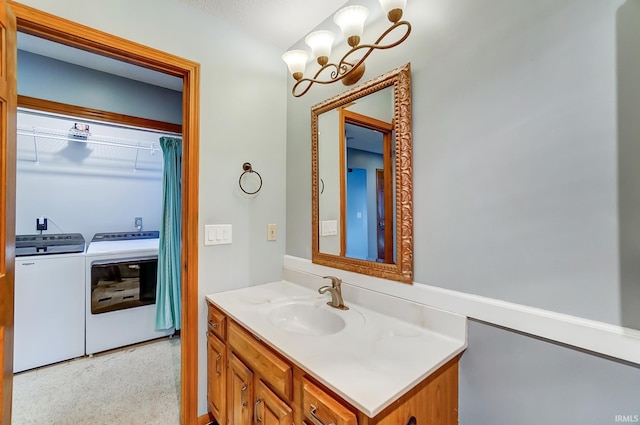 bathroom featuring washing machine and dryer and vanity