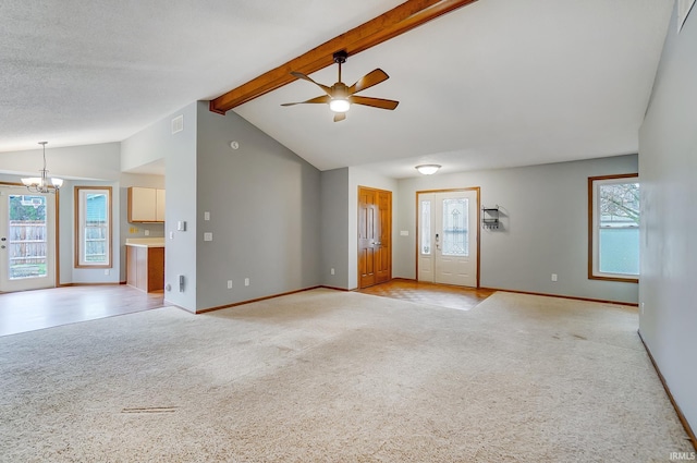 unfurnished living room with light carpet, ceiling fan with notable chandelier, beam ceiling, and a healthy amount of sunlight