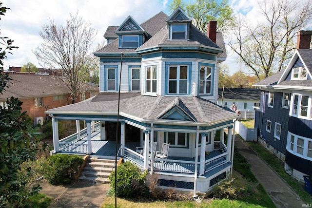 126 E 4th St, Mount Carmel, IL 62863 - victorian house with a porch and a shingled roof