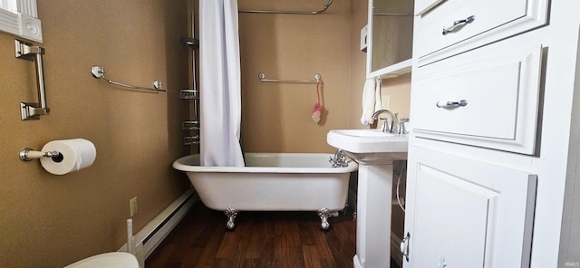 126 E 4th St, Mount Carmel, IL 62863 - full bath with a freestanding bath, wood finished floors, and a baseboard heating unit