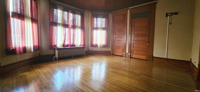 126 E 4th St, Mount Carmel, IL 62863 - empty room featuring radiator, wood finished floors, and baseboards