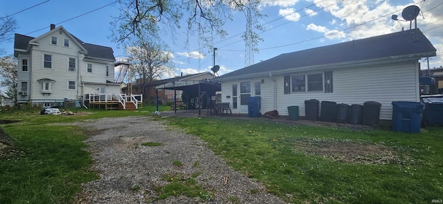 126 E 4th St, Mount Carmel, IL 62863 - rear view of property featuring a patio area and a lawn