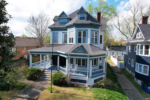 126 E 4th St, Mount Carmel, IL 62863 - victorian home with roof with shingles and covered porch