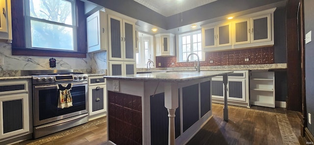 126 E 4th St, Mount Carmel, IL 62863 - kitchen with light stone counters, a kitchen island, gas range, dark wood finished floors, and a sink