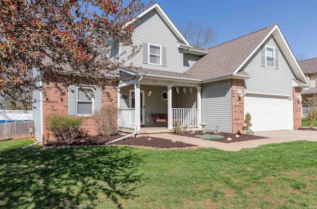 traditional-style house featuring an attached garage, a front yard, brick siding, fence, and covered porch