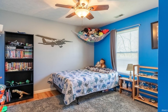 bedroom with visible vents, baseboards, and a ceiling fan