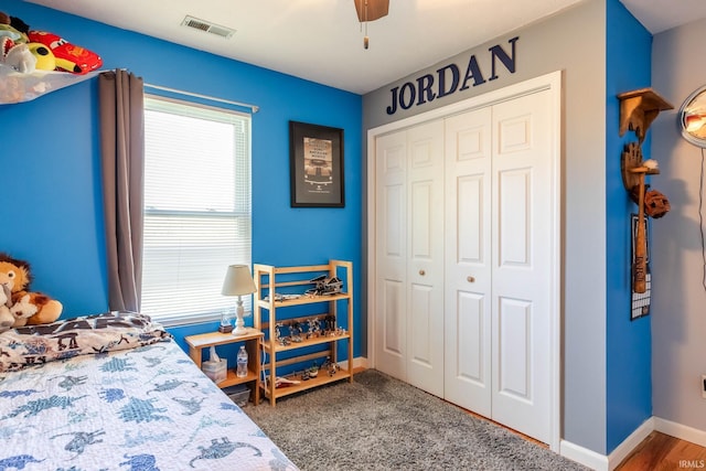 bedroom featuring a closet, ceiling fan, baseboards, and visible vents