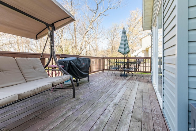 wooden deck featuring outdoor dining space and grilling area