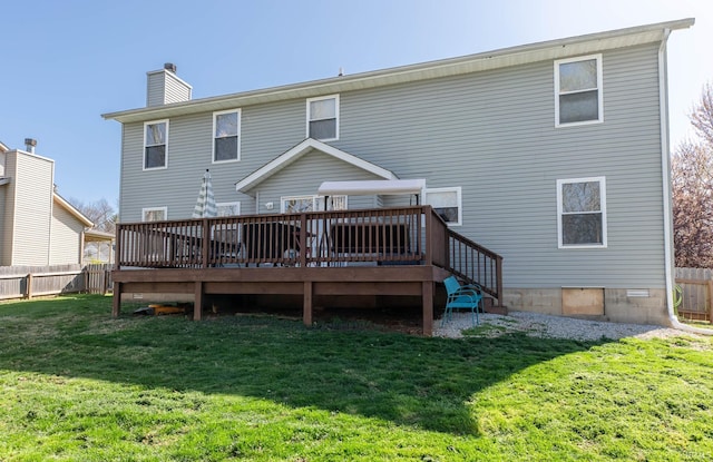 rear view of property with a yard, a wooden deck, fence, and a chimney