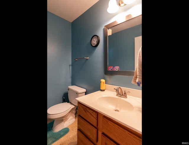 half bathroom with toilet and vanity