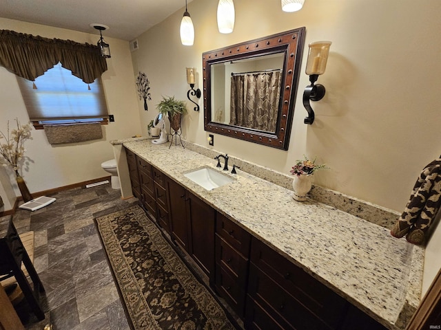 501 Monticello Dr, Vincennes, IN 47591 - full bath with vanity, stone finish flooring, toilet, a shower with shower curtain, and baseboards