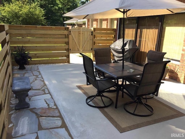 501 Monticello Dr, Vincennes, IN 47591 - view of patio / terrace featuring grilling area, outdoor dining space, fence, and a gate
