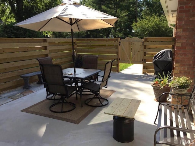 501 Monticello Dr, Vincennes, IN 47591 - view of patio with a gate, fence, outdoor dining area, and area for grilling