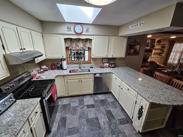 501 Monticello Dr, Vincennes, IN 47591 - kitchen featuring a sink, appliances with stainless steel finishes, a peninsula, under cabinet range hood, and a skylight