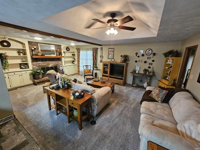 501 Monticello Dr, Vincennes, IN 47591 - living area with a raised ceiling, carpet flooring, a ceiling fan, and built in shelves