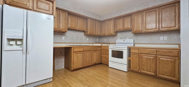 402 Easy St, Mount Carmel, IL 62863 - kitchen with white appliances, light wood-style flooring, tasteful backsplash, brown cabinetry, and light countertops