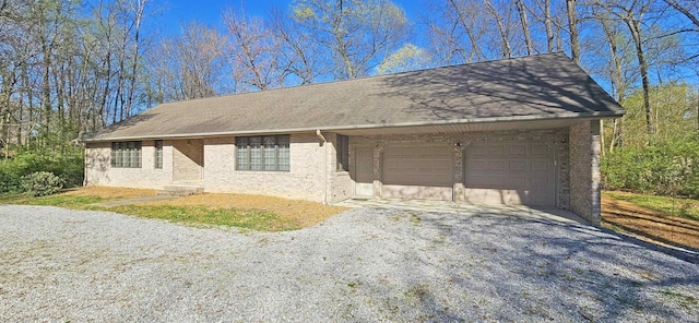 402 Easy St, Mount Carmel, IL 62863 - single story home with brick siding, gravel driveway, roof with shingles, and an attached garage