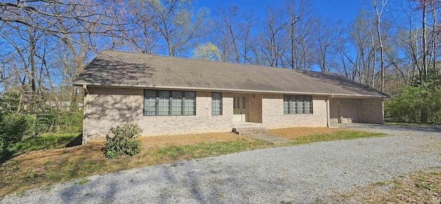 402 Easy St, Mount Carmel, IL 62863 - view of front of home with gravel driveway, brick siding, and a carport