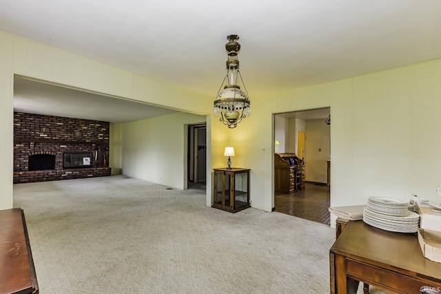 411 S County Road 550 E, Selma, IN 47383 - living area featuring brick wall, a fireplace, and carpet flooring