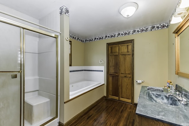 411 S County Road 550 E, Selma, IN 47383 - full bath with a sink, a bath, a stall shower, and wood finished floors