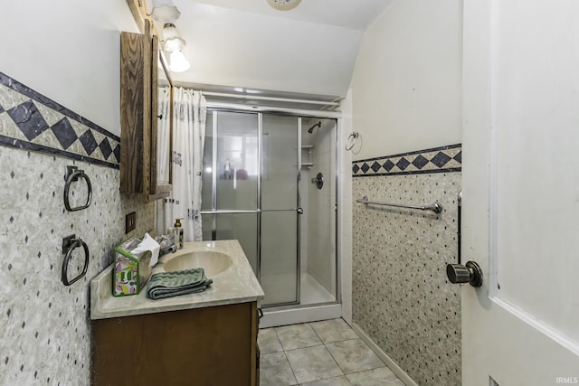 411 S County Road 550 E, Selma, IN 47383 - full bathroom featuring tile walls, a wainscoted wall, a shower stall, vanity, and tile patterned floors