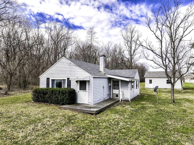 411 S County Road 550 E, Selma, IN 47383 - back of property with roof with shingles, a deck, a chimney, and a lawn