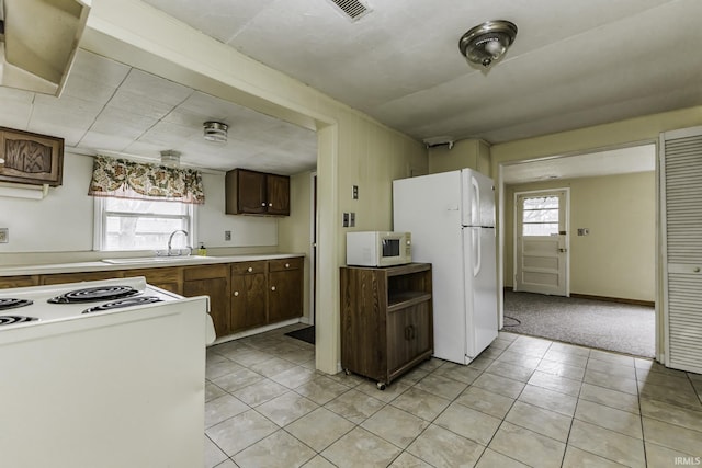 411 S County Road 550 E, Selma, IN 47383 - kitchen featuring a sink, light countertops, white appliances, and plenty of natural light