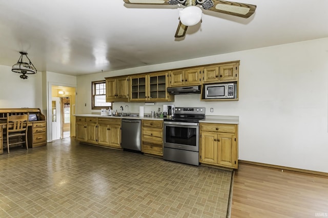 411 S County Road 550 E, Selma, IN 47383 - kitchen with a ceiling fan, appliances with stainless steel finishes, under cabinet range hood, light countertops, and baseboards