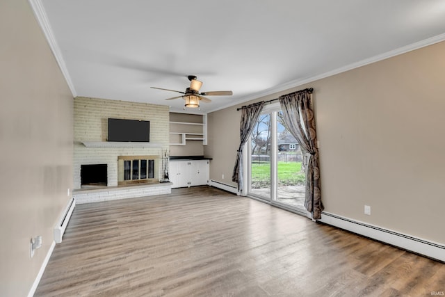 unfurnished living room with baseboard heating, a baseboard heating unit, a ceiling fan, and crown molding