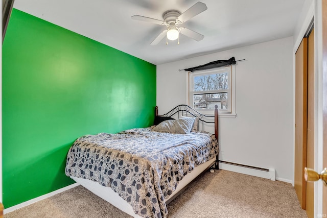 bedroom featuring carpet, a closet, a ceiling fan, baseboard heating, and baseboards