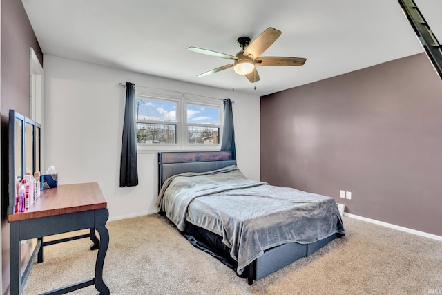 bedroom with ceiling fan, baseboards, and carpet floors