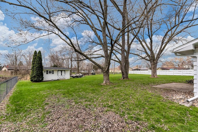 view of yard featuring an outdoor structure and fence