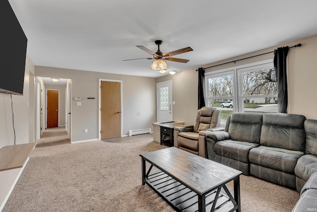 living room with a baseboard radiator, light colored carpet, baseboards, and a ceiling fan