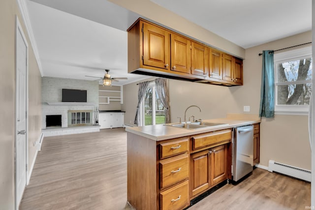 kitchen featuring light wood-style floors, ceiling fan, stainless steel dishwasher, baseboard heating, and a sink