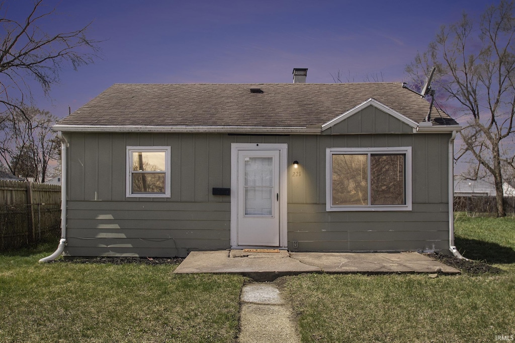 221 N Kenmore St, South Bend, IN 46619 - bungalow with a front yard, fence, a patio, and roof with shingles