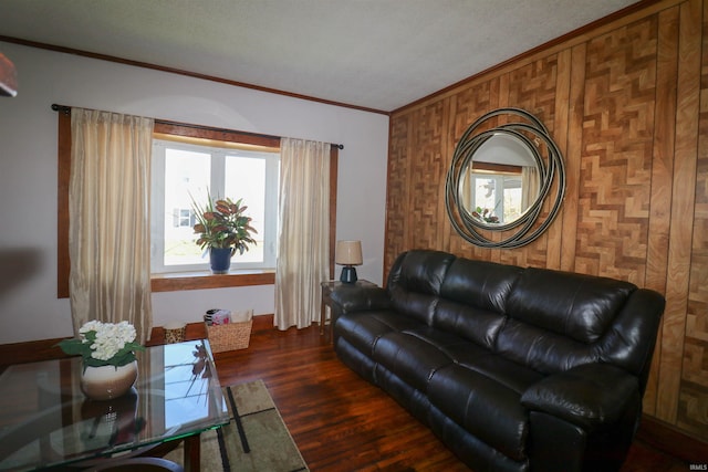 living area featuring crown molding, wood finished floors, and wooden walls