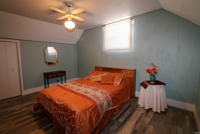 bedroom with baseboards, lofted ceiling, and dark wood-style floors