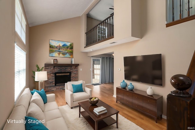 526 Cambridge Dr, Kokomo, IN 46902 - living room with high vaulted ceiling, a brick fireplace, visible vents, and wood finished floors