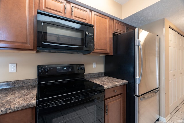 526 Cambridge Dr, Kokomo, IN 46902 - kitchen with dark countertops, black appliances, light tile patterned flooring, and brown cabinets