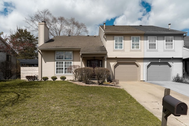 526 Cambridge Dr, Kokomo, IN 46902 - tri-level home featuring a chimney, concrete driveway, a garage, and a front yard