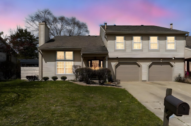 526 Cambridge Dr, Kokomo, IN 46902 - split level home with concrete driveway, a chimney, a garage, and a lawn