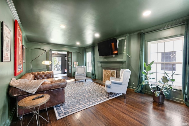 4707 Old Mill Rd, Fort Wayne, IN 46807 - living room featuring a fireplace with flush hearth, wood finished floors, crown molding, and a healthy amount of sunlight