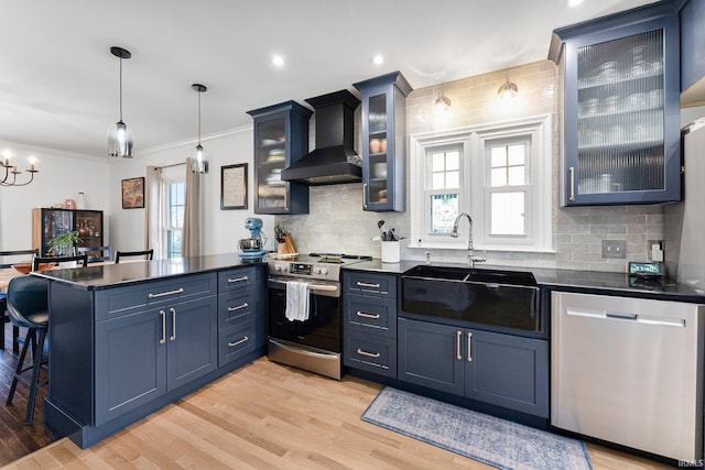 4707 Old Mill Rd, Fort Wayne, IN 46807 - kitchen with wall chimney exhaust hood, a sink, a wealth of natural light, a peninsula, and stainless steel appliances