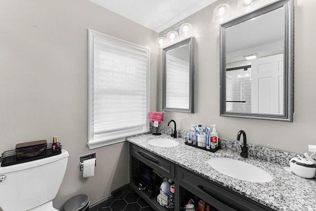 4707 Old Mill Rd, Fort Wayne, IN 46807 - full bathroom featuring a sink, toilet, double vanity, and tile patterned flooring